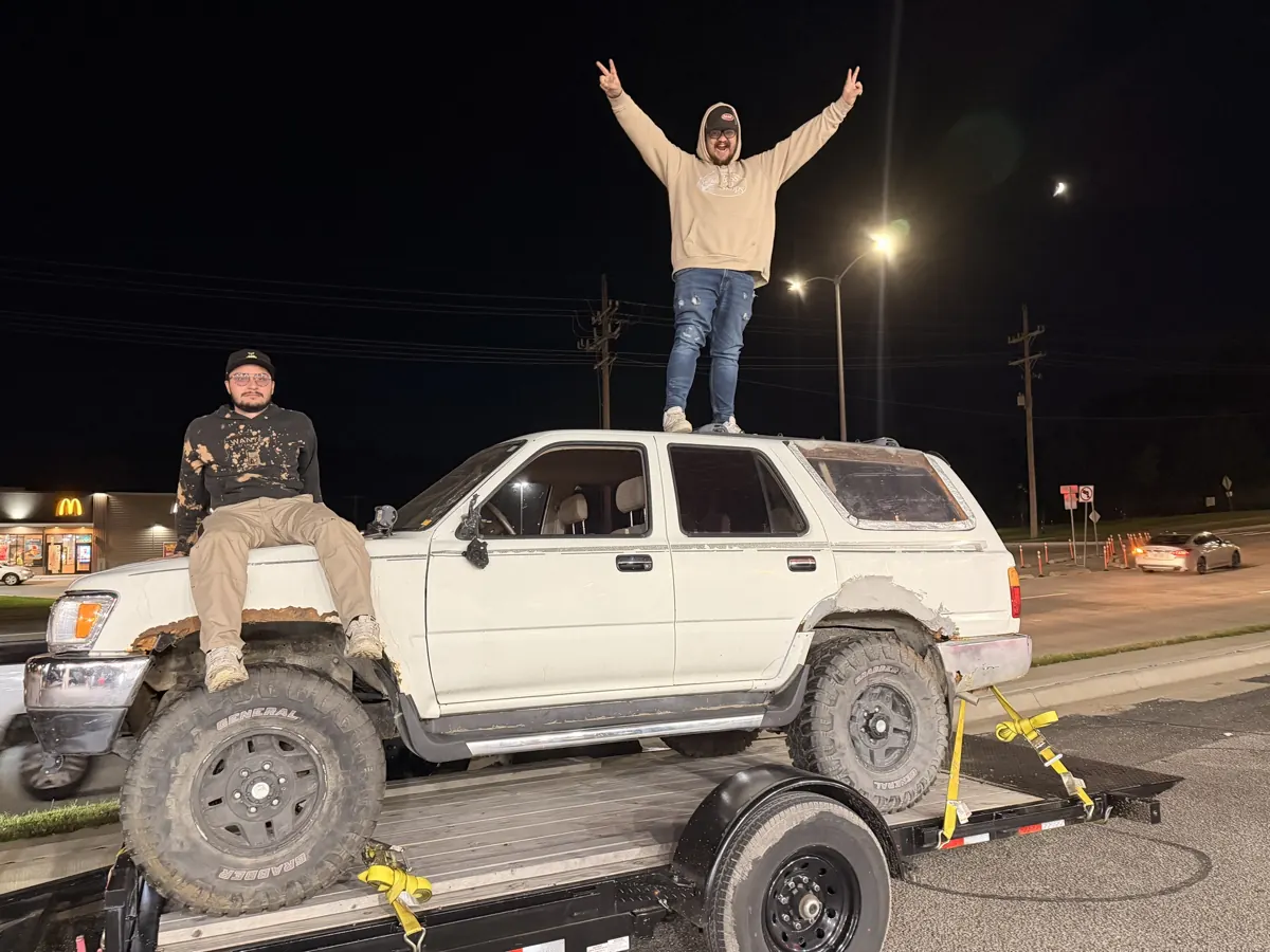The CNL Auto Works team with a Toyota 4Runner loaded on a trailer at night